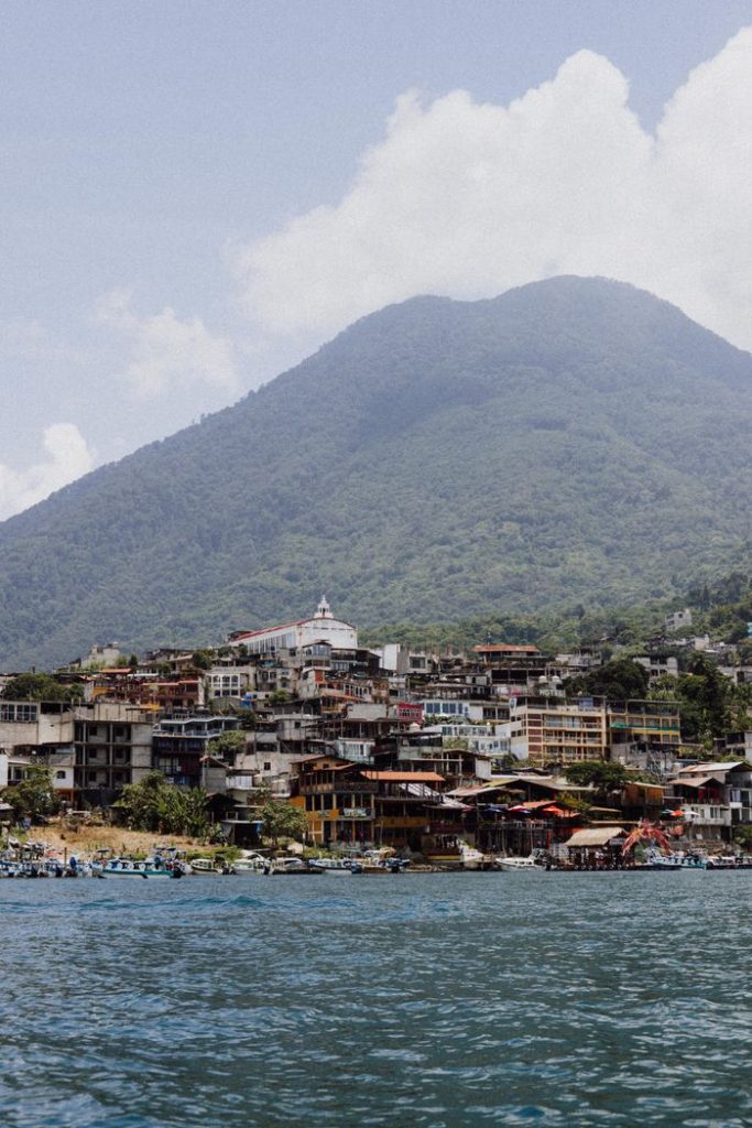 Scenic landscape of San Pedro La Laguna by the lake with majestic volcanic backdrop.
